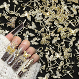 50Stück 3D Złota kokardka Charms do paznokci Motyl Nail Art Charms Legierung Bogen Nagel Charms Nägel Zubehör Schleife Nagelschmuck Metall Schleifen Schmetterling Nageldesign Nagelanhänger Nailart Strasssteine