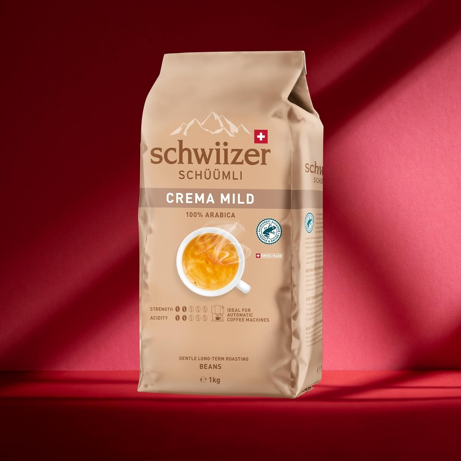 Schwiizer Schüümli Crema Mild, 100% ziaren kawy Arabica drobne, harmonijne i łagodne, idealne do automatycznych ekspresów ciśnieniowych, moc 2/5, jasno palone, Rainforest Alliance, 1kg