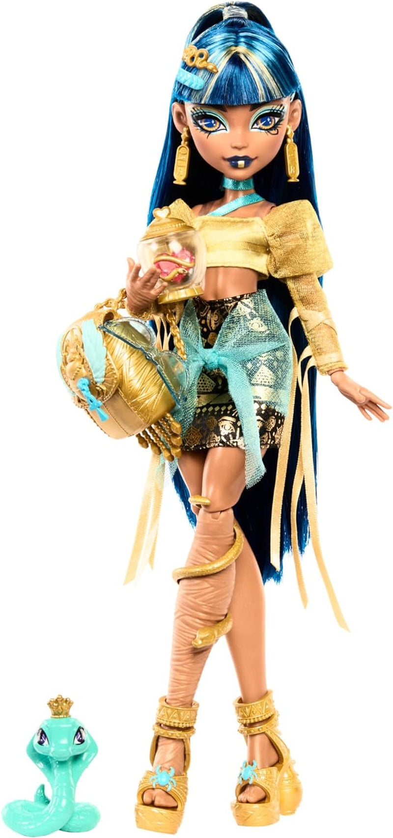 Lalka Monster High Cleo De Nile w złotej bluzce i warstwowej spódnicy, zawiera kobrę Hissette i akcesoria, takie jak tornister, przekąskę i rolkę papieru toaletowego, HXH74