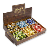Prezentacja topu czekoladowego Lindor | 1718 g i tabliczki czekolady z marcepanem | 25 batonów x 50g w displayu naladowym | 1250 g | Czysty marcepan oblany ciemną czekoladą | Batony czekoladowe