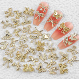 50Stück 3D Złota kokardka Charms do paznokci Motyl Nail Art Charms Legierung Bogen Nagel Charms Nägel Zubehör Schleife Nagelschmuck Metall Schleifen Schmetterling Nageldesign Nagelanhänger Nailart Strasssteine