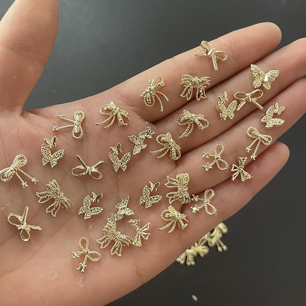 50Stück 3D Złota kokardka Charms do paznokci Motyl Nail Art Charms Legierung Bogen Nagel Charms Nägel Zubehör Schleife Nagelschmuck Metall Schleifen Schmetterling Nageldesign Nagelanhänger Nailart Strasssteine
