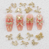 50Stück 3D Złota kokardka Charms do paznokci Motyl Nail Art Charms Legierung Bogen Nagel Charms Nägel Zubehör Schleife Nagelschmuck Metall Schleifen Schmetterling Nageldesign Nagelanhänger Nailart Strasssteine